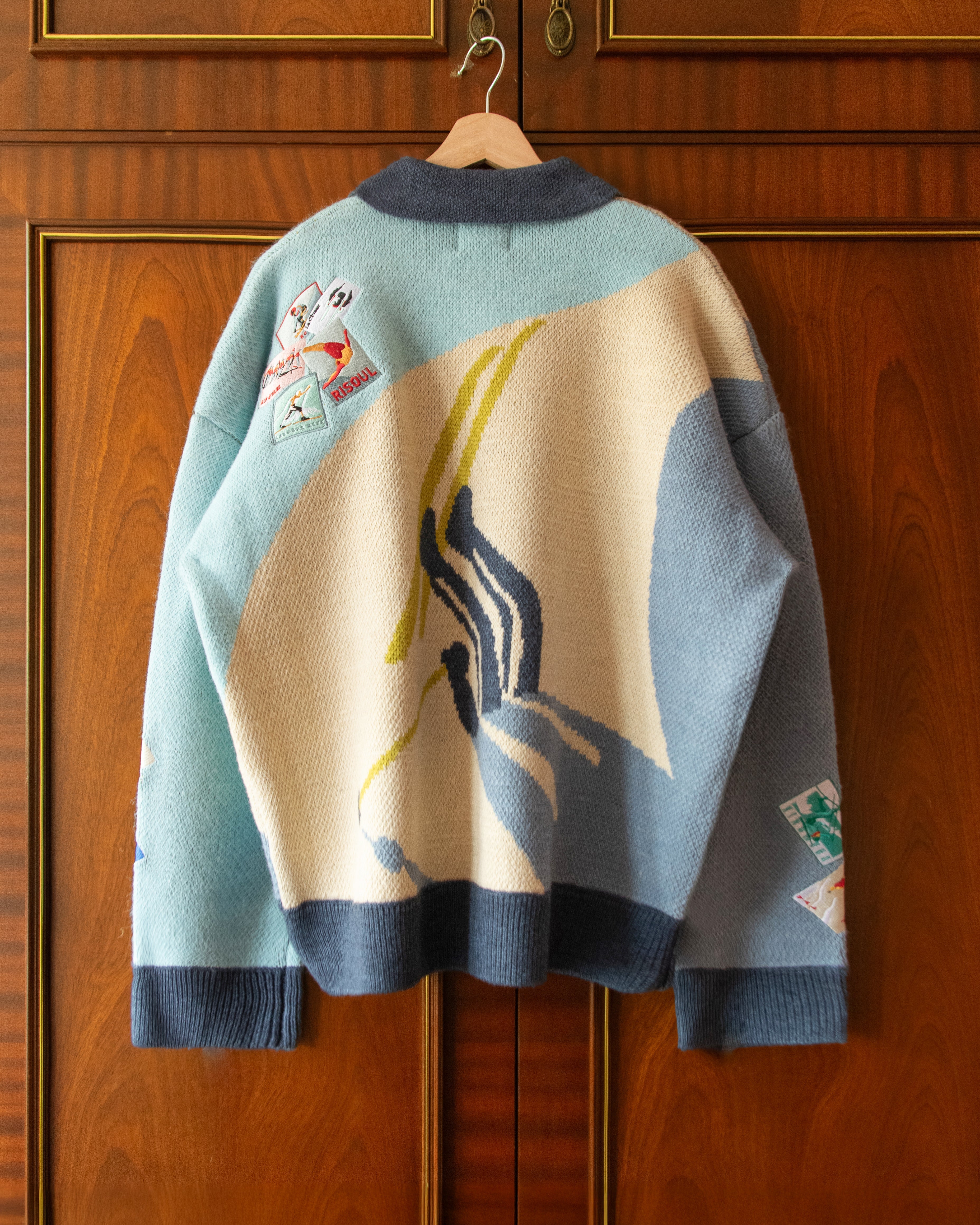 KNITTED SKI JUMPER WITH EMBROIDERED POSTCARDS