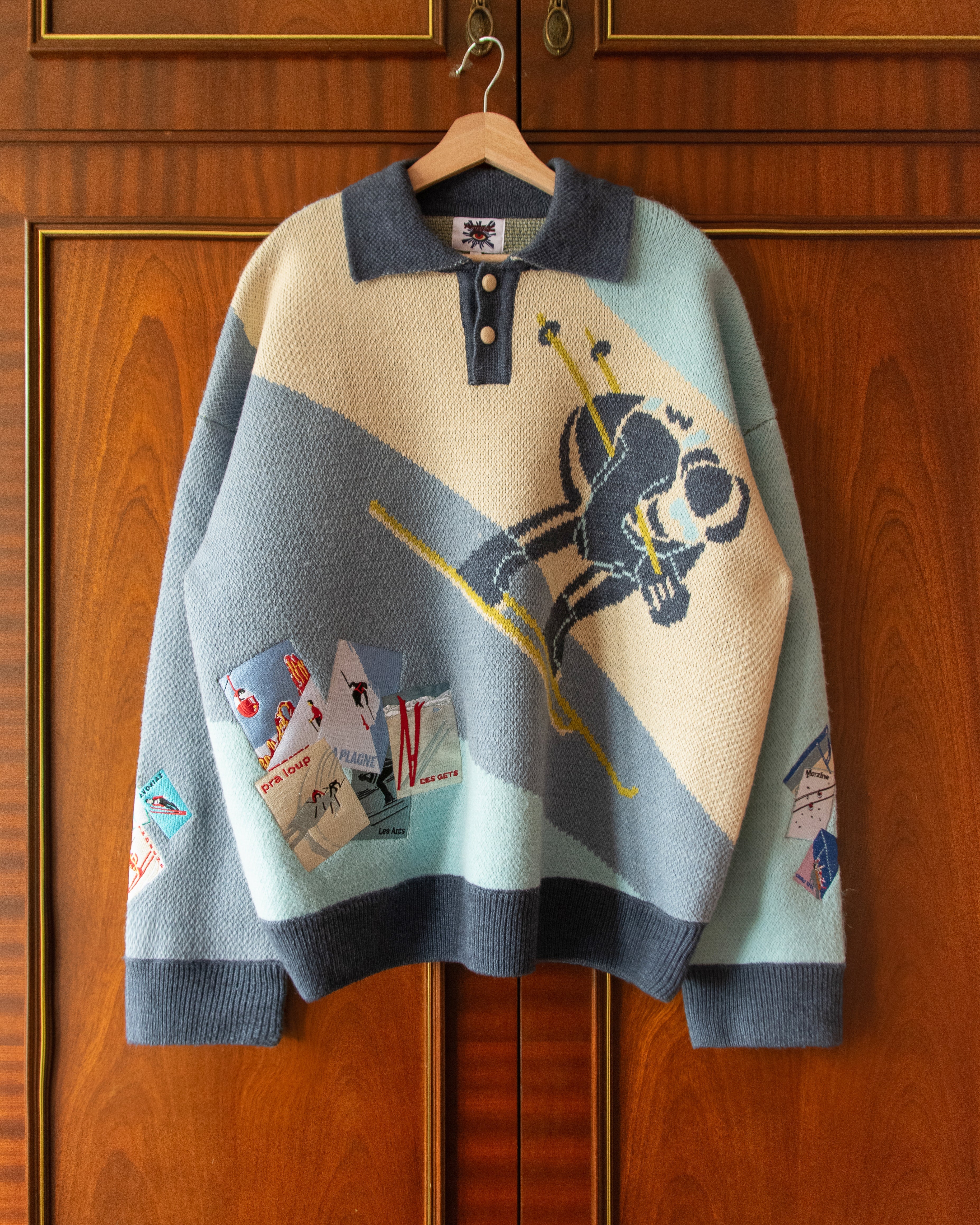 KNITTED SKI JUMPER WITH EMBROIDERED POSTCARDS